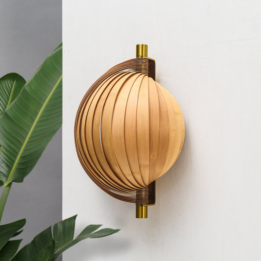 Handmade bamboo seashell wall lamp with brass accents, featuring a curved, layered design for modern home decor.