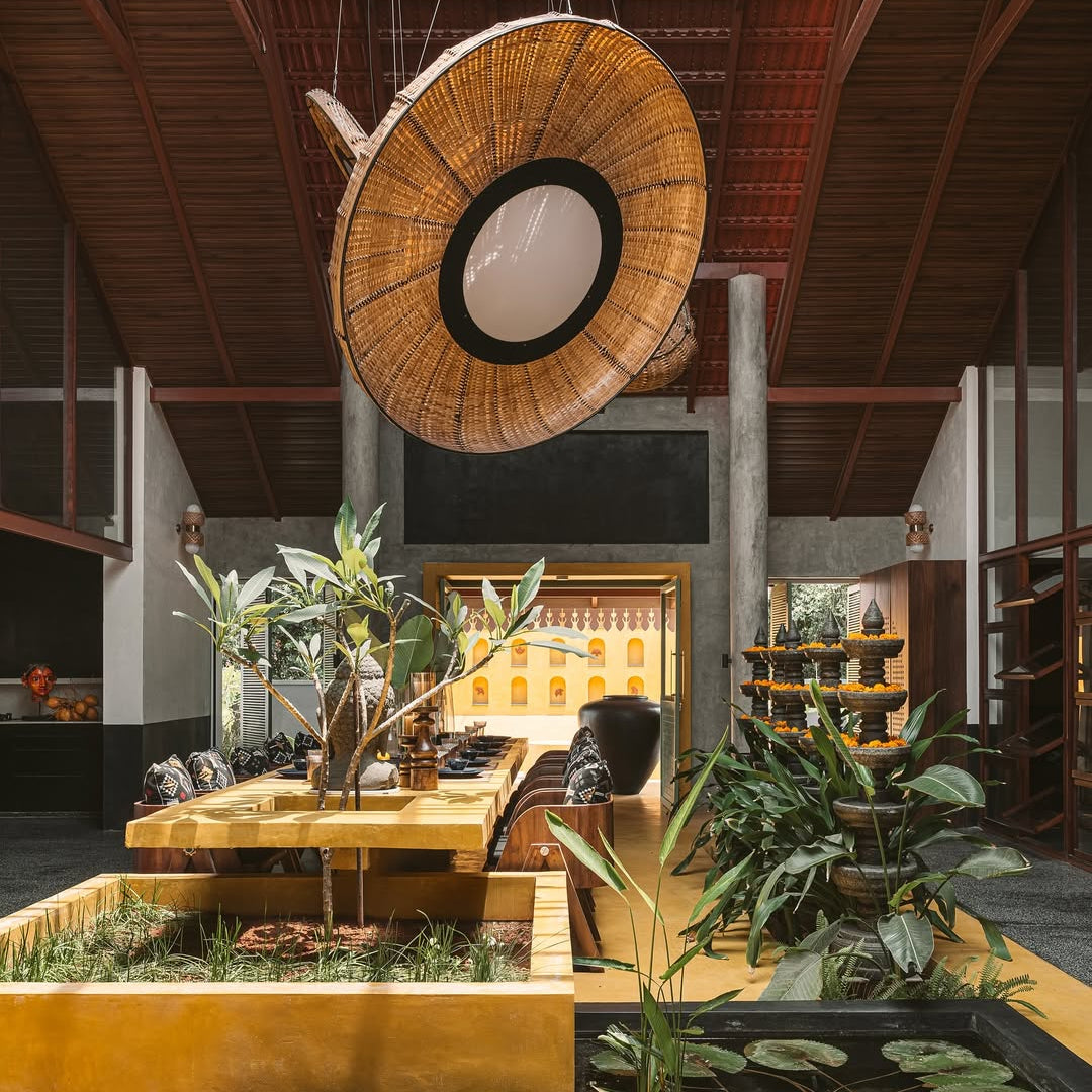 Large Lilypad bamboo chandelier hanging over a Japandi-style dining room with natural wood textures and indoor greenery.